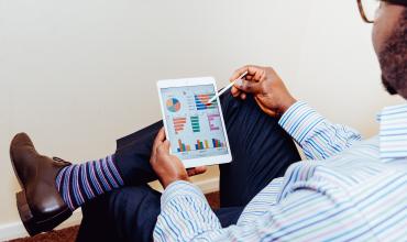 A man sitting and using a tablet