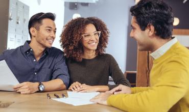 Home buyers sitting at a table with a lender