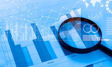 A magnifying glass over bar graphs