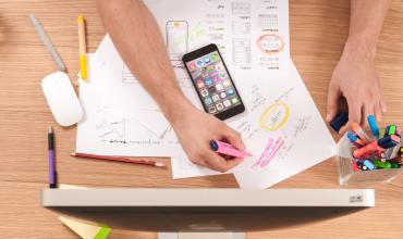 A person working with papers at a desk