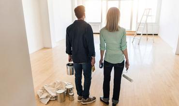 a couple standing and admiring the inside of their new home