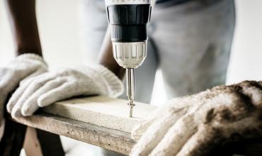 A worker using a power drill