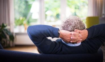 An older man relaxing on a couch