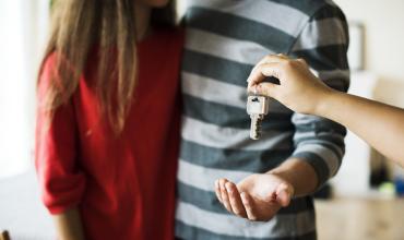 a couple being handed a house key