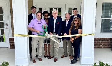 Photo of ribbon cutting with giant scissors 