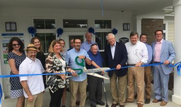 a ribbon cutting event at greenfield place apartments