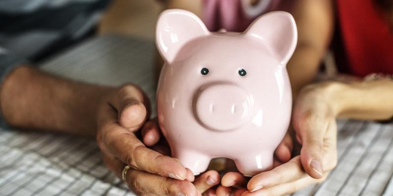 Couple holding a piggy bank 