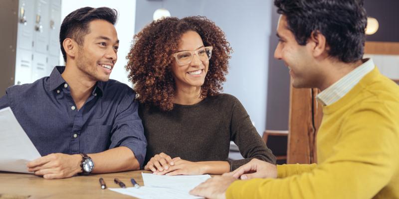 Home buyers sitting at a table with a lender