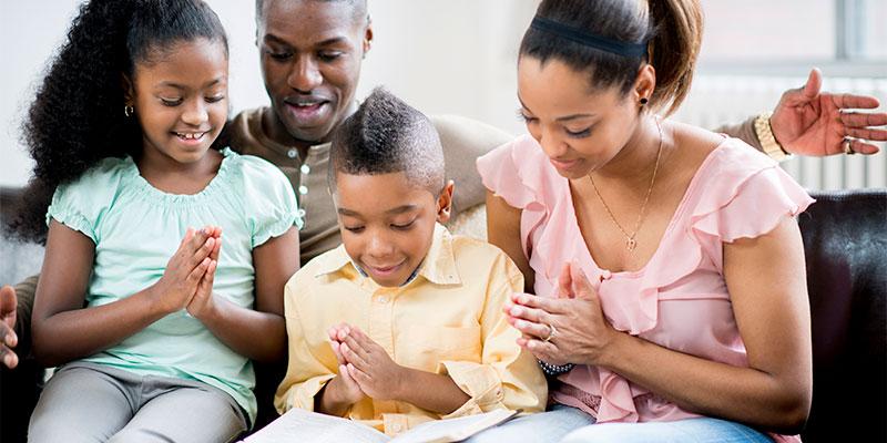 family of four reading together