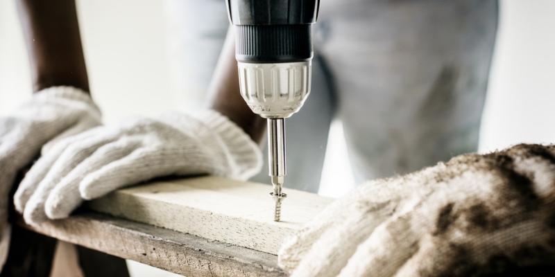 construction worker using a power drill