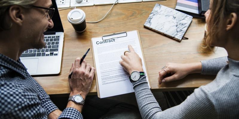 People talking at a table looking at papers